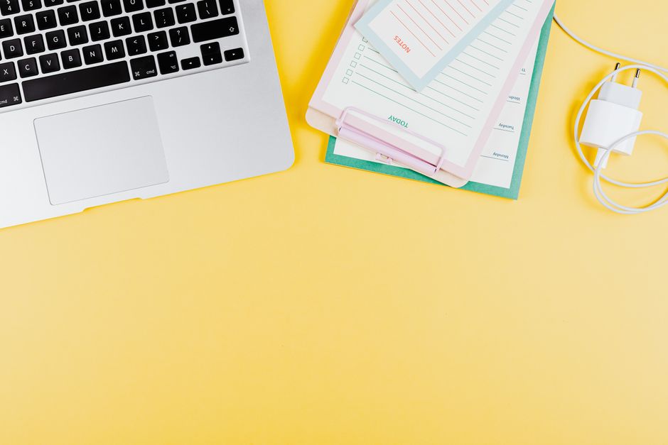 A bright, minimal, and organized professional desk with a planner and coffee, symbolizing the clarity and calm that comes from proactive planning for a high-stress project.